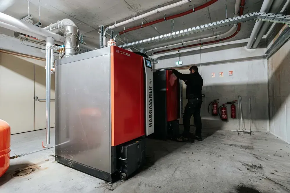 Chauffagiste entrain de réaliser le contrôle et suivi technique d’une chaudière 