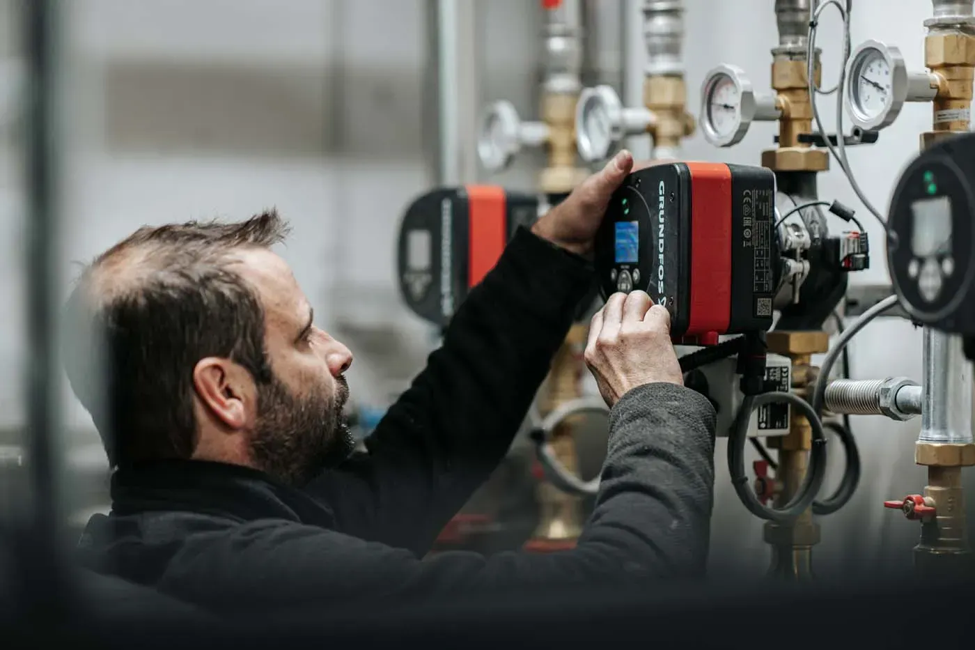 Technicien intervenant sur une installation de chauffage en chaufferie collective